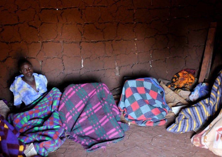 A teenager from Uganda's Sebei tribe sits inside a mud hut after undergoing female genital mutilation in Bukwa district, about 357 kms (214 miles) northeast of Kampala, December 15, 2008. The ceremony was to initiate teenage girls into womanhood according to Sebei traditional rites. REUTERS/James Akena (UGANDA)