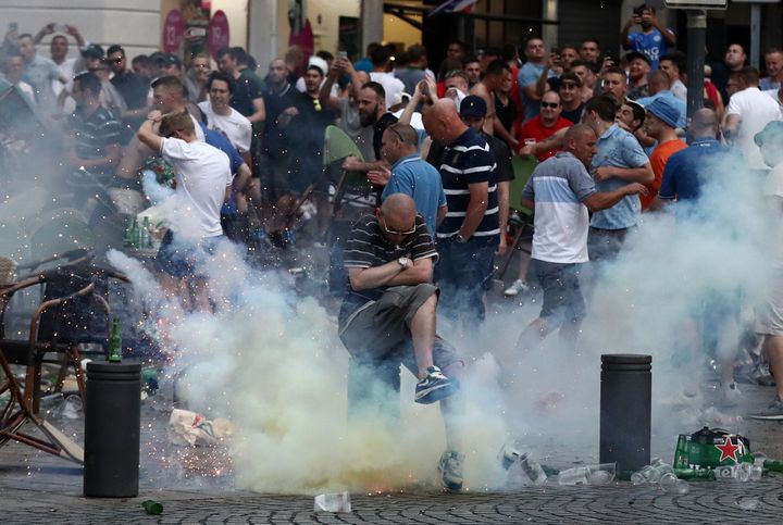 A tear gas canister explodes under a football fan as England fans clash with police on June 10, 2016 in Marseille.