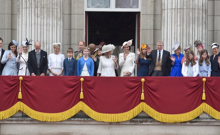 Members of the royal family wait on the balcony of Buckingham Palace for Queen Elizabeth to return after the Trooping the Col