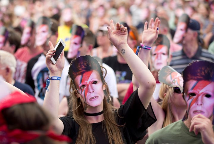 Thousands of Isle Of Wight Festival goers donned David Bowie masks in tribute to the pop giant during the first major music festival of the summer