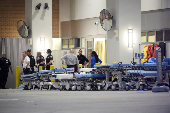 Emergency personnel wait with stretchers at the emergency entrance to Orlando Regional Medical Center hospital for the arrival of patients following a mass shooting.