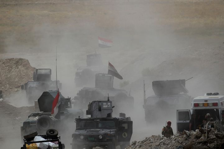 Vehicles of the Iraqi security forces move toward Falluja on the outskirts of the city in Iraq, June 10, 2016.