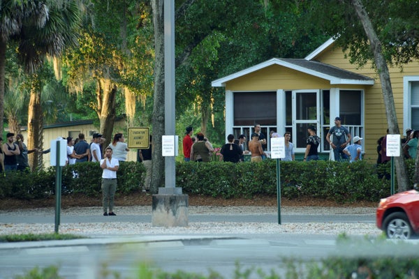 People gather as police conduct questioning near Pulse nightclub, where people were killed by a gunman in a shooting rampage 