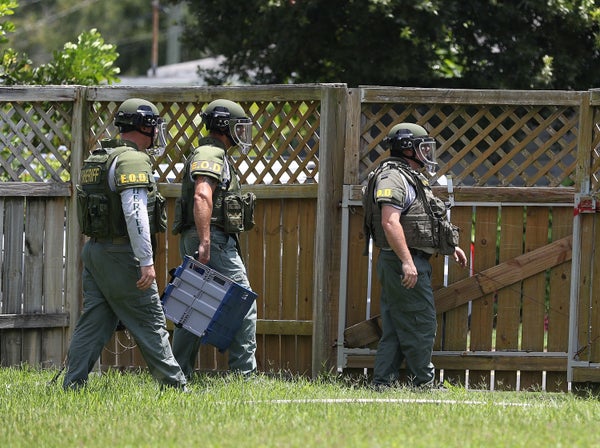 A Bomb Disposal Unit checks for explosives around the apartment building where shooting suspect Omar Mateen is believed to ha