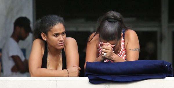 Concerned friends and family of victims of the Pulse nightclub shooting wait outside of the Orlando Police Department on Sund
