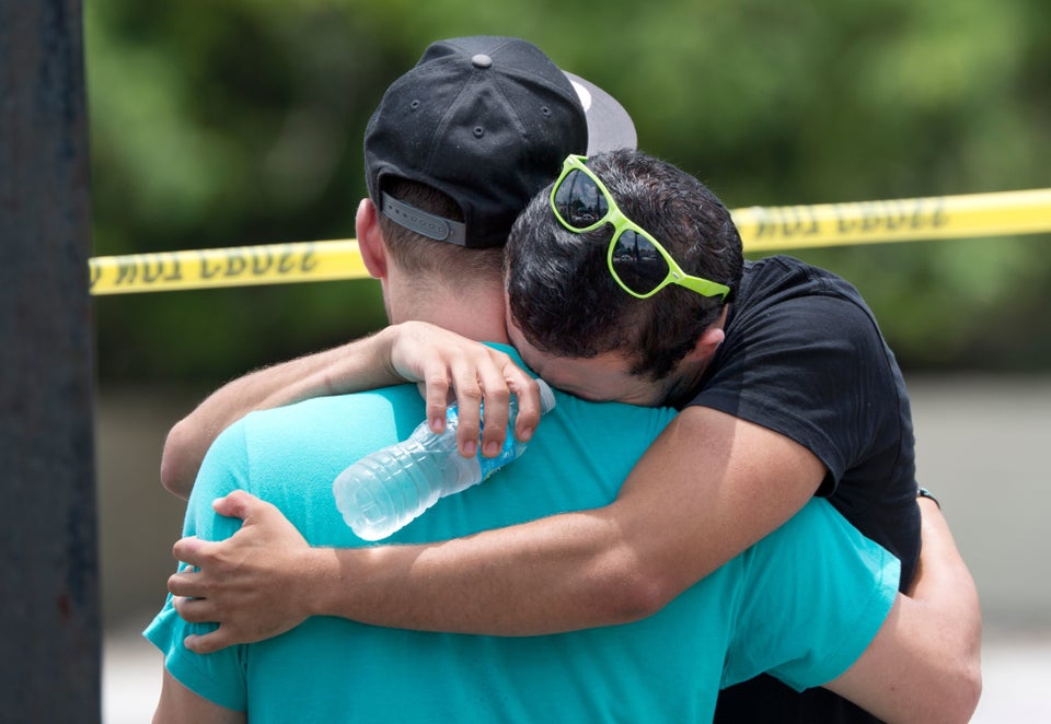 Supported by a friend, a man weeps for victims of the mass shooting just a block from the scene in Orlando, Florida, on June 