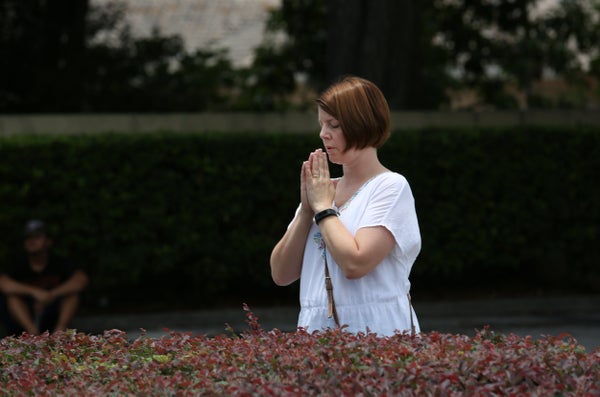A woman prays at a site about a block from the Pulse nightclub in the aftermath of a mass shooting in Orlando, Florida, on Ju