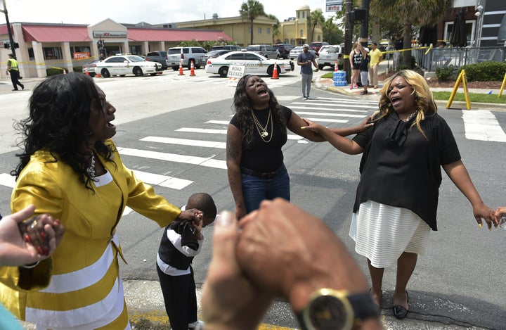 Women pray outside Pulse nightclub on Sunday, the day of the shooting.