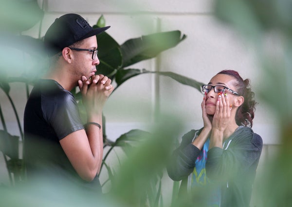 People react the Pulse nightclub shooting outside the hotel where family members are gathering in Orlando, Florida, on June 1