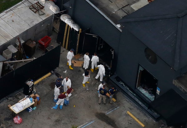 Police forensics investigators work at the crime scene of a mass shooting at the Pulse gay night club in Orlando, Florida, U.