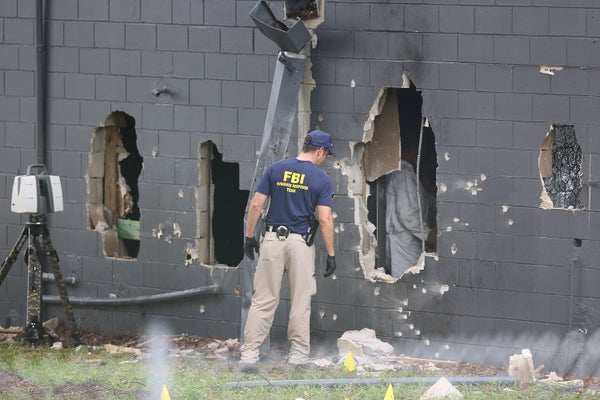 FBI agents investigate the damaged rear wall of the Pulse Nightclub where Omar Mateen allegedly killed at least 50 people on 