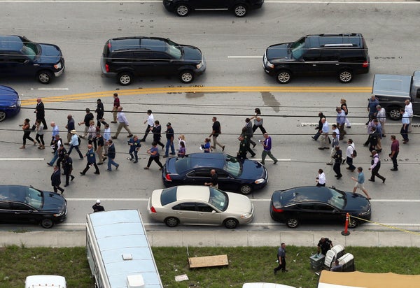 Law enforcement walk south of the mass shooting scene at Pulse nightclub in Orlando, Fla., on Sunday, June 12, 2016.&nbsp;