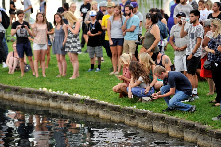 Orlando residents light candles during a vigil at Lake Eola Park for victims of the shooting.