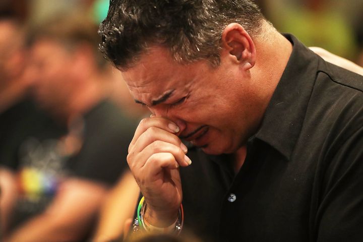 A man who was injured in the mass shooting at Pulse nightclub cries as he attends a memorial service at the Joy Metropolitan Community Church.