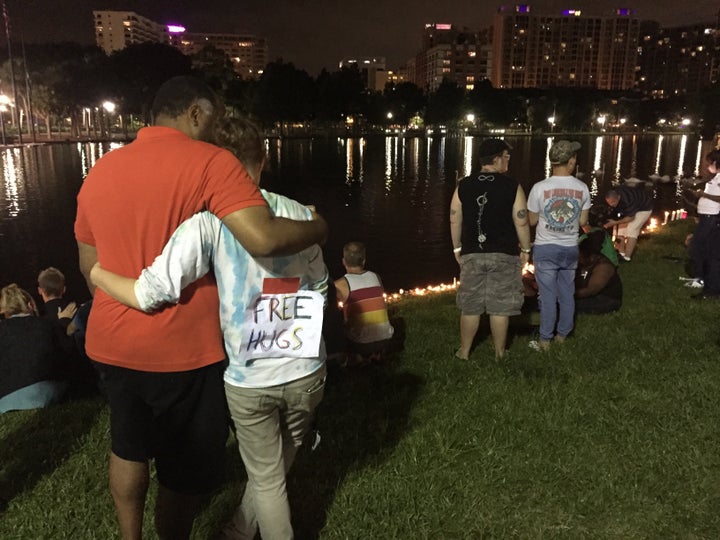 People gather at Lake Eola Park to remember the victims.