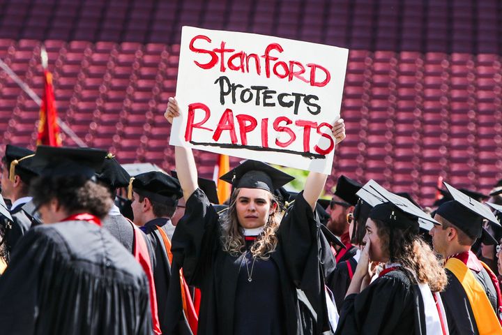 A woman carries a sign in solidarity for a Stanford rape victim during graduation at Stanford University, in Palo Alto, California, on June 12, 2016.