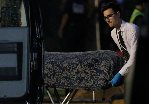 A body is removed as Police forensic investigators work at the crime scene of a mass shooting at the Pulse gay night club in 
