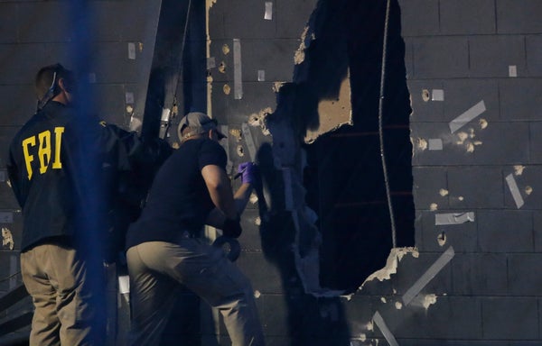 Police forensic investigators work at the crime scene of a mass shooting at the Pulse gay night club in Orlando, Florida, U.S