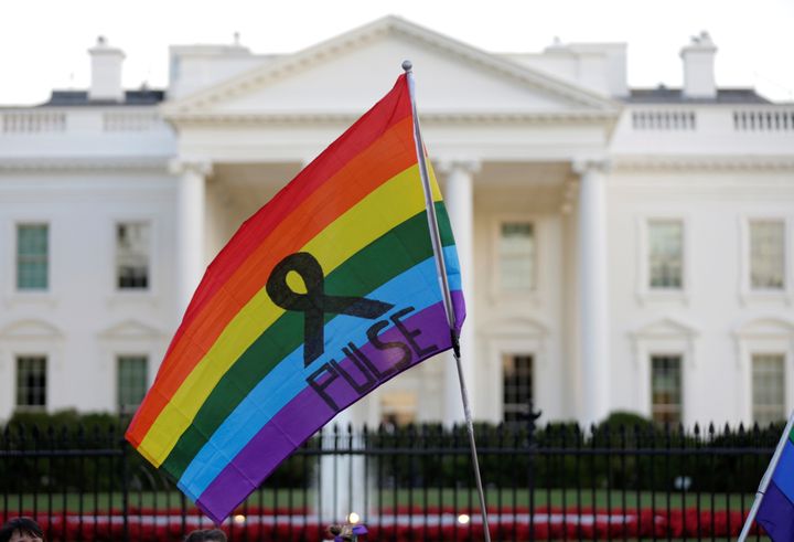 A rainbow flag is seen waving before the White House with the name of the gay nightclub where a gunman, who was fatally shot by police, killed 49 people and wounded 53 others Sunday.