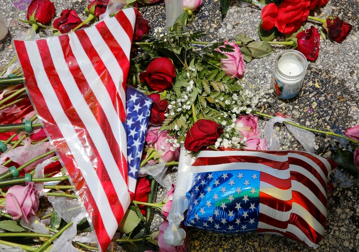 A vigil is seen near the site of the shooting at the Pulse gay night club in Orlando, Florida, June 13, 2016.