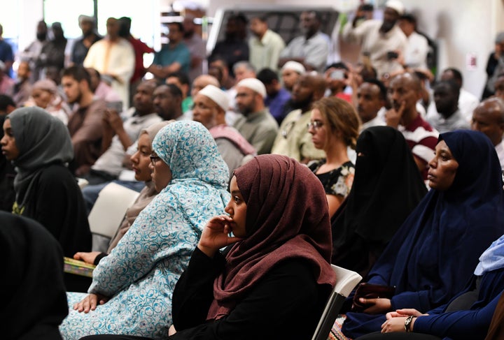 Ebtesam Mohammed, middle, and other young women listen and reflect during a press conference at the Colorado Muslim Society in response to the Orlando nightclub shooting massacre on June 12, 2016 in Denver, Colorado.