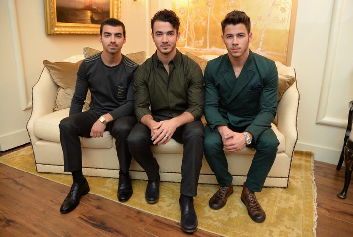 Joe, Kevin and Nick Jonas attend Mercedes-Benz Fashion Week in 2013.