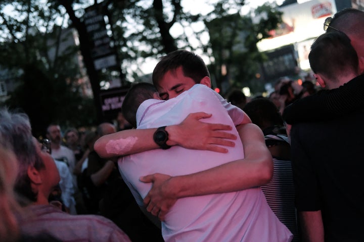 Mourners gather outside of the iconic New York City gay and lesbian bar The Stonewall Inn to light candles,lay flowers and grieve for those killed in Orlando last evening on June 12, 2016 in New York City.