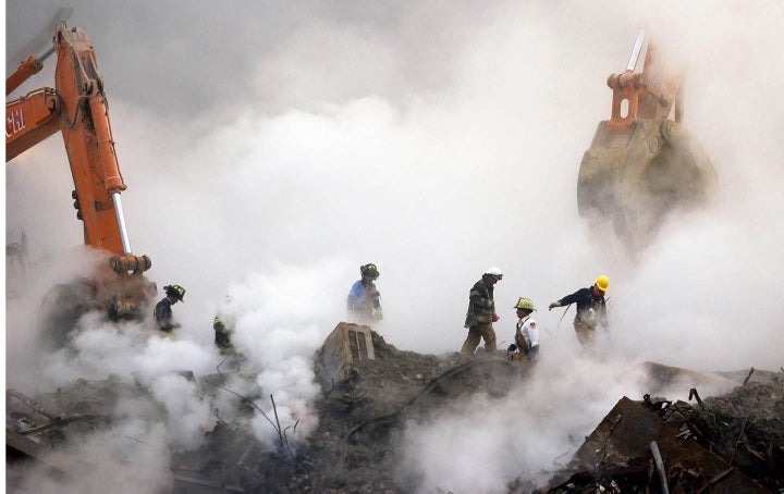 Fire fighters dig through rubble at Ground Zero