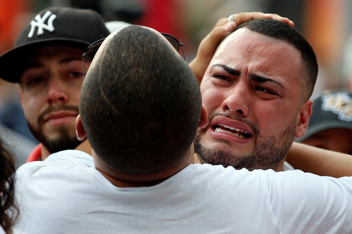 People attend a memorial service the day after a mass shooting at the Pulse gay nightclub in Orlando, Florida, U.S. June 13, 2016.