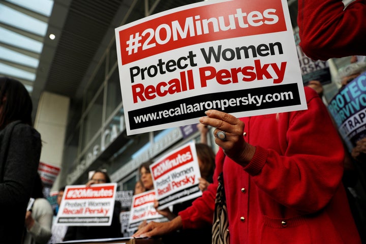 Activists in San Francisco, California hold signs calling for the removal of Judge Aaron Persky from the bench after his controversial sentencing in the Stanford rape case.