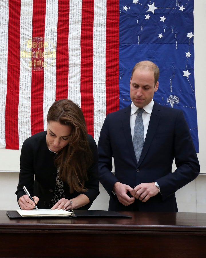 Will and Kate write a message of condolences at the U.S. Embassy in London.