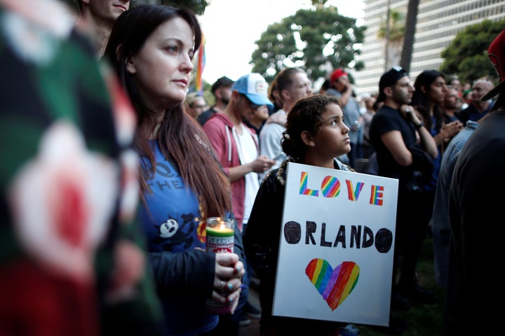 People attend a vigil being held in Los Angeles on Monday for the victims a mass shooting at the Pulse gay nightclub in Orlando, Florida.