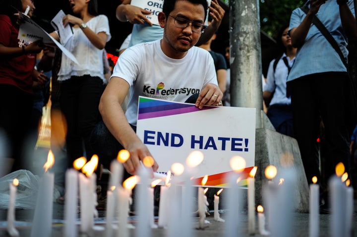 Candles are seen being lit during a vigil that was held for the victims in Manila, Philippines, on Tuesday.