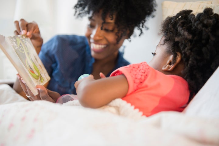 Mother and daughter reading in bed JGI/Jamie Grill via Getty Images