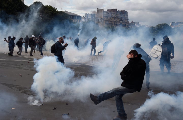 Police say they fired dozens of volleys of teargas and used water cannon against gangs of masked youths at a protest against labor laws.