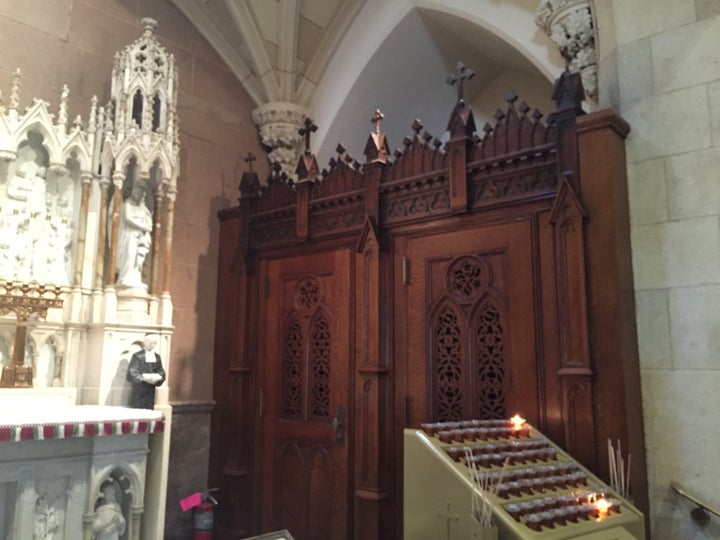 A small, enclosed confessional booth.