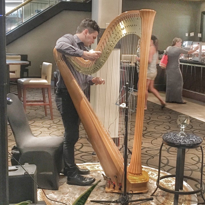 Matthew Tutsky preps his harp to accompany the Riverside's killer brunch. The harp pairs well with bottomless mimosas.