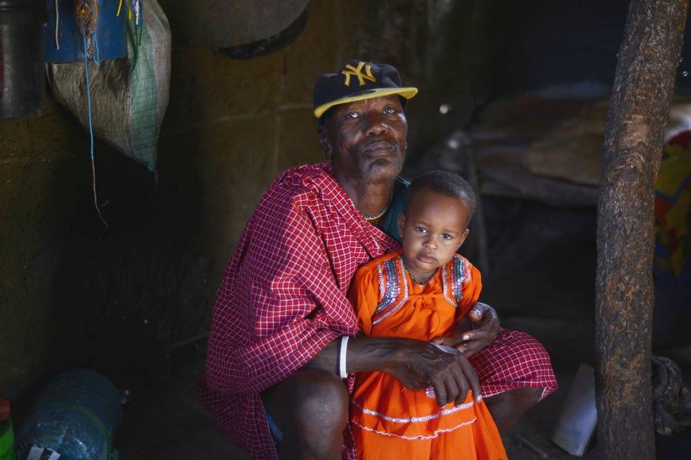 Salumu Kundaya Kidomwita, 60, with the youngest of his 22 children.
