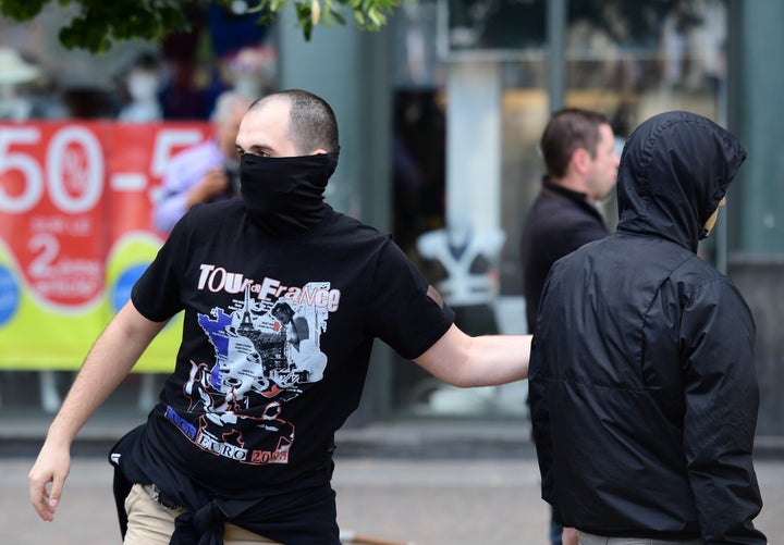 <strong>A Russian football fans taunts England fans who are drinking at a nearby cafe in Lille</strong>