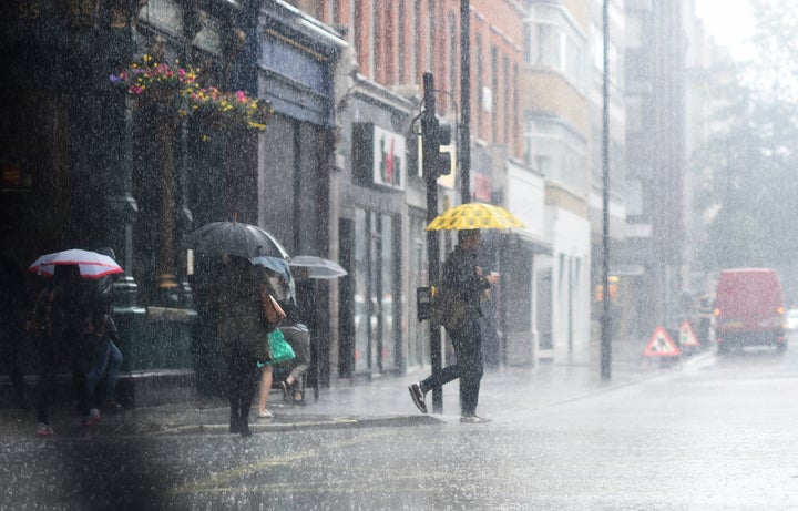 A man gets caught in a downpour on Tuesday