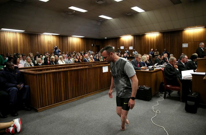 Oscar Pistorius walks across the courtroom without his prosthetic legs during the third day of the resentencing hearing for the 2013 murder of his girlfriend Reeva Steenkamp