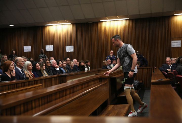 Pistorius prepares to remove his prosthetic legs for the demonstration