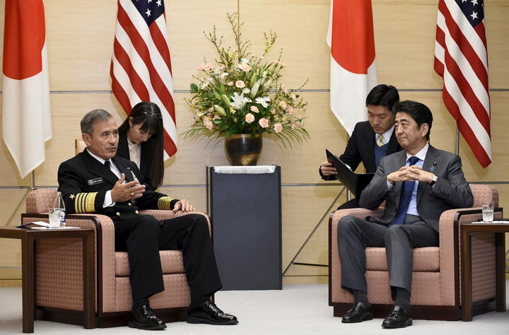 Japan's Prime Minister Shinzo Abe (R) meets U.S. Navy Admiral Harry B. Harris Jr., Commander of the United States Pacific Com