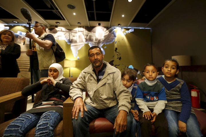 Syrian refugee Ahmad al Aboud, center, and his family members, who will be resettled in the U.S. as part of a refugee admissions programme, wait for their plane at Queen Alia International Airport in Amman, Jordan, April 6, 2016.