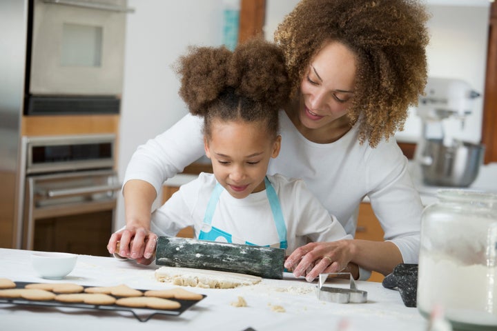 Black mother and daughter baking together Ariel Skelley via Getty Images