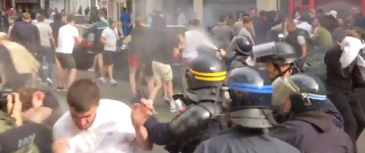 Police can be seen spraying tear gas