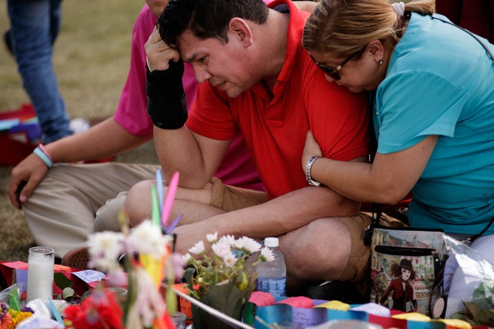 Cesar Rodriguez, friend of Amanda Alvear who was killed in the Orlando shooting, is comforted by Lisa Dominguez at a makeshift memorial at the Dr. Phillips Center for Performing Arts, June 14, 2016 in Orlando, Florida.