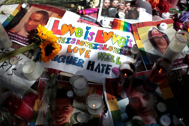 Images of victims and messages are seen at a makeshift memorial to remember the victims of the mass shooting at a gay nightcl