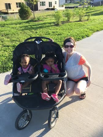 Kendra, 1; Olivia, 2; take candid photo with mom and baby sister Addison along a bike trail in West Des Moines, IA.