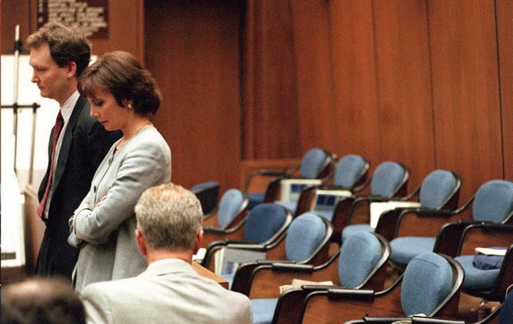 Prosecutors Hank Goldberg and Marcia Clark stand next to the empty jury box.